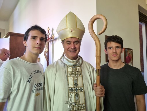 Monsignor Roberto Repole con due giovani braidesi